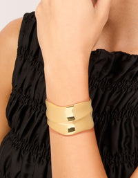 Featuring a gold plated wide organic wrist cuff in statement bangle style on wrist view - link has visual effect only