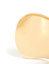 Showcasing a gold plated wide organic wrist cuff in statement bangle style close up view - link has visual effect only