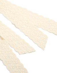 Featuring delicate floral lace fabric, this ivory bow clip showcases intricate detailing in detail view - link has visual effect only