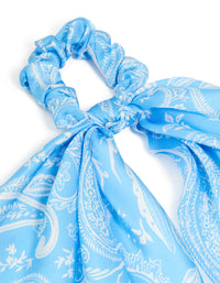 Highlighting a light blue paisley printed fabric scarf scrunchie with leaf accents in white side view - link has visual effect only