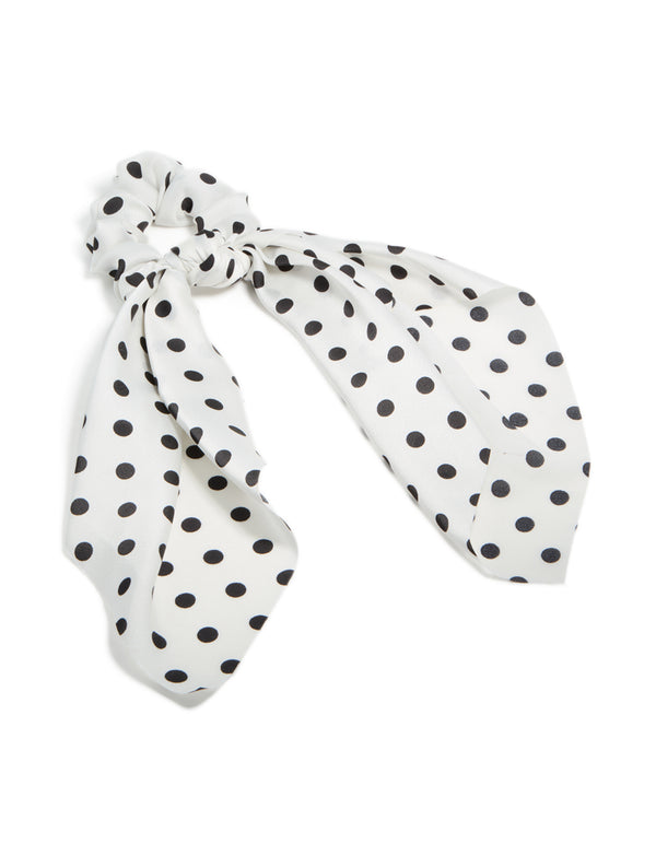 Crafted from polyester featuring polka dot print in white and black scarf scrunchie front view