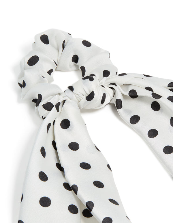 Featuring polyester with polka dot print in white and black scarf scrunchie side view