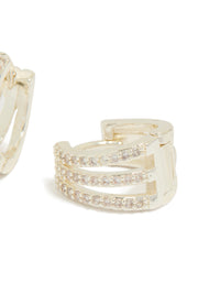 Crafted trio layered huggie earrings featuring cubic zirconia in silver plated finish post detail view - link has visual effect only