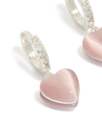 Elegant dainty hoop earrings with heart drop, crafted from silver plated cubic zirconia in light pink close up view - link has visual effect only