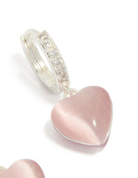 Explore dainty hoop earrings with heart drop, crafted from silver plated cubic zirconia in light pink post detail view - link has visual effect only