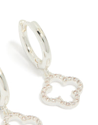 Highlighting silver plated cubic zirconia flower huggie drop earrings in dainty hoop closure post detail view - link has visual effect only