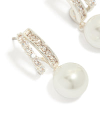 Featuring silver plated cubic zirconia illusion pearl drop earrings with hoop closure close up view - link has visual effect only