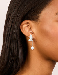 Presenting silver plated enamel butterfly pearl drop earrings worn for scale and placement on ear view - link has visual effect only