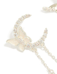Detailed view of silver plated cubic zirconia moon and butterfly drop earrings with celestial charm pearl accents close up view - link has visual effect only