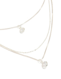 Showcasing a triple-layered drop necklace with beads, round-cut cubic zirconia, crafted from silver-plated material in a silver color close up view - link has visual effect only