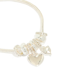 Featuring silver plated diamante heart rondell charm bracelet with beads in close up view - link has visual effect only