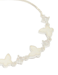 Crafted in silver plated finish, this toggle bracelet features smooth butterfly charms and cubic zirconia inlay close up view - link has visual effect only