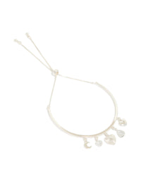 Showcasing a silver plated moon and heart charm toggle bangle with celestial details front view - link has visual effect only