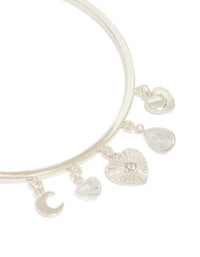 Designed with silver plated finish, this moon and heart charm toggle bangle features celestial elements close up view - link has visual effect only