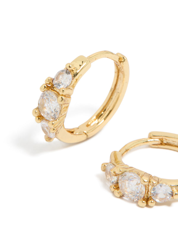 Shop gold plated mixed sized cubic zirconia mini huggie earrings with huggie closure close up view