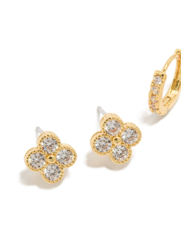 Highlighting gold plated flower earrings with clear stones close up view