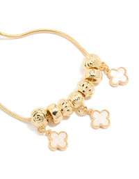 Designed with gold plated beaded bracelet featuring white genuine shell flower inlay charms with toggle closure in close up view - link has visual effect only