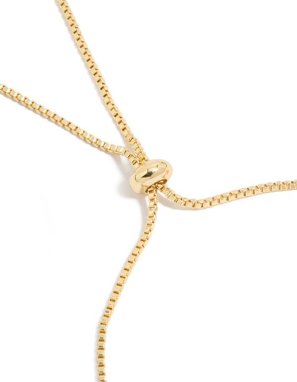 Crafted from gold plated material, this floral bracelet displays cubic zirconia embellishments with white inlay and toggle closure detail view
