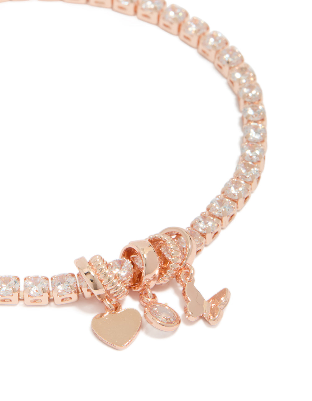 Detailed view of mixed charm tennis bracelet highlighting butterfly, heart, and cubic zirconia accents in rose gold plated finish close up view