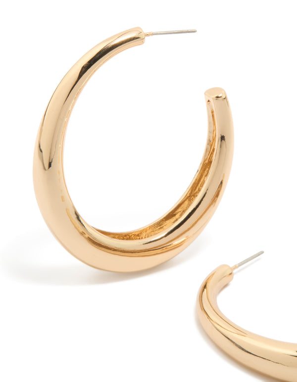 Featuring gold plain wide hoop earrings close up view