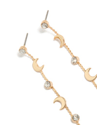 Featuring gold clear diamante and celestial thin drop earrings with close up view - link has visual effect only
