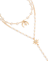 Showcasing a statement necklace featuring celestial moon and star charms with a pearl, crafted from gold plated material, close up view - link has visual effect only