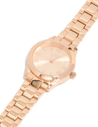 Showcasing a rose gold classic round roman numeral watch with numbers on pink dial, women's link band, formal occasion, analog timepiece watch face detail view - link has visual effect only