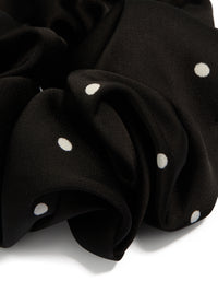 Crafted from polka dot patterned fabric, this statement scrunchie features micro dots in black and white detail view - link has visual effect only