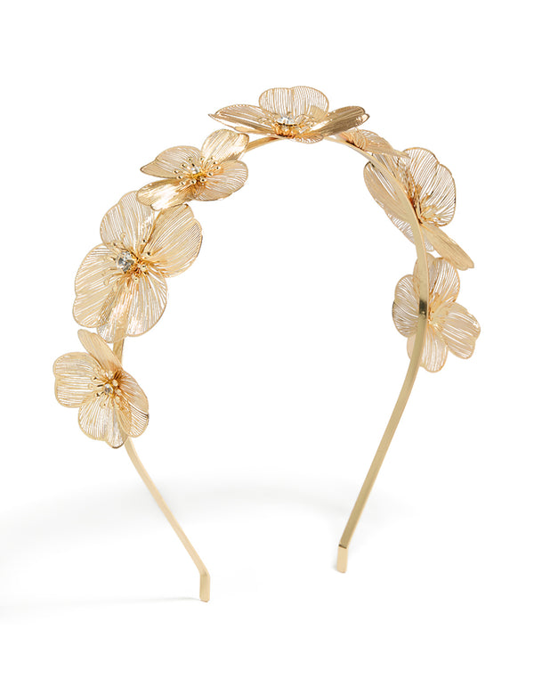 Showcasing a laser cut flowers headband in gold front view