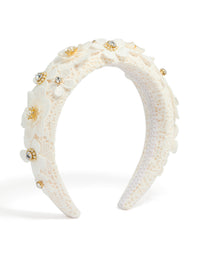 Showcasing a white padded lace headband embellished with floral accents and pearl in ivory, beige, and gold tones front view - link has visual effect only