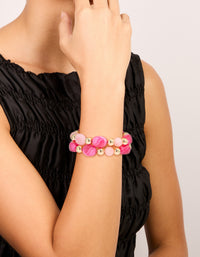 Crafted from hot pink and light pink acrylic with gold beaded stretch bracelets shown in a 2-pack on wrist view - link has visual effect only