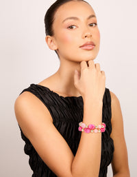 Designed with hot pink and light pink acrylic beads featuring gold accents in a 2-pack stretch bracelet set on model view - link has visual effect only