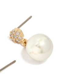 Crafted from gold plated material featuring small round cubic zirconia and pearl drop earrings in white post detail view - link has visual effect only