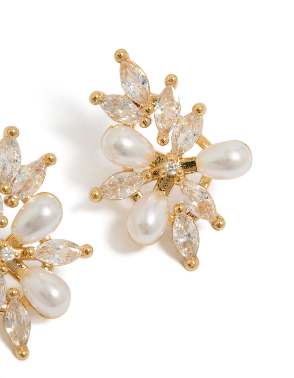 Elegant gold plated cubic zirconia organic flower and pearl earrings in statement style close up view