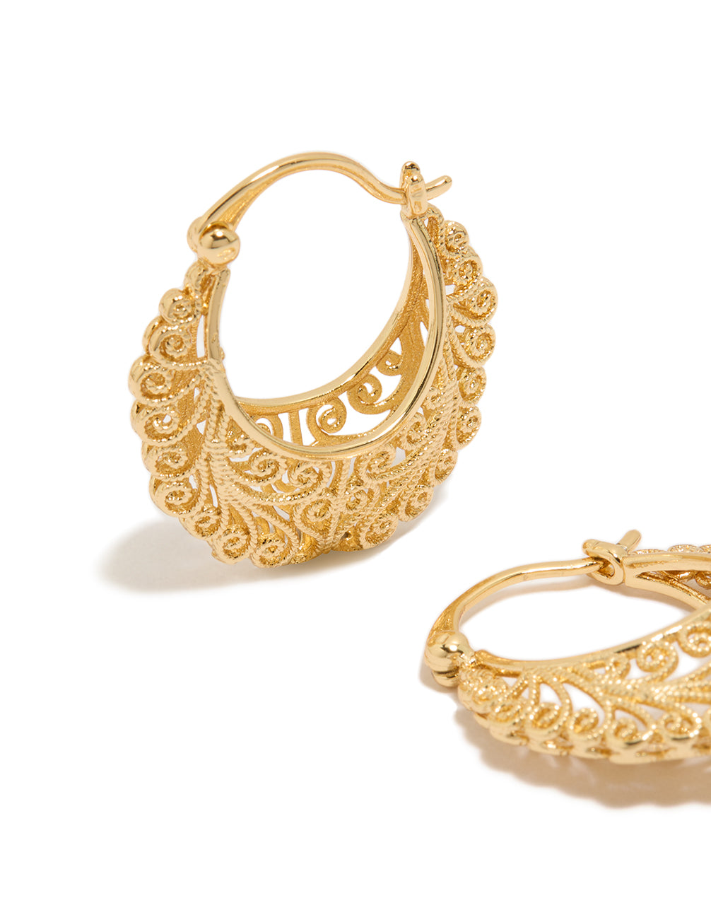 Highlighting gold plated boho patterned hoop earrings close up view