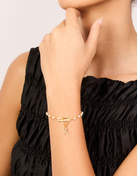 Elegant gold plated pearl and cubic zirconia bracelet with celestial star and moon charm worn on wrist view - link has visual effect only