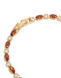 Displaying a gold plated tennis bracelet with clear and cognac cubic zirconia in multi cut closure detail view - link has visual effect only
