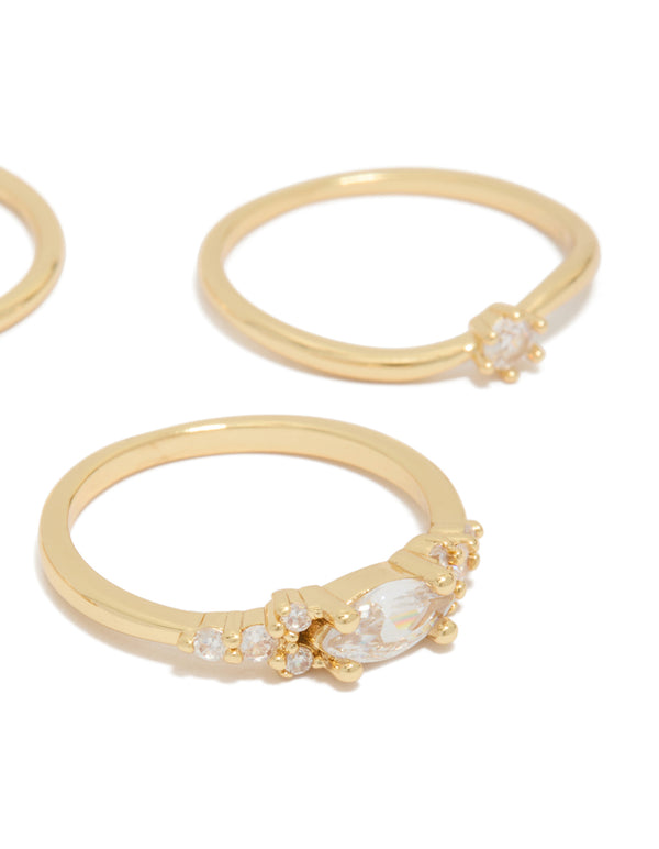 Featuring gold plated cubic zirconia wavy bezel set rings 4-pack highlighting stone settings and band details close up view