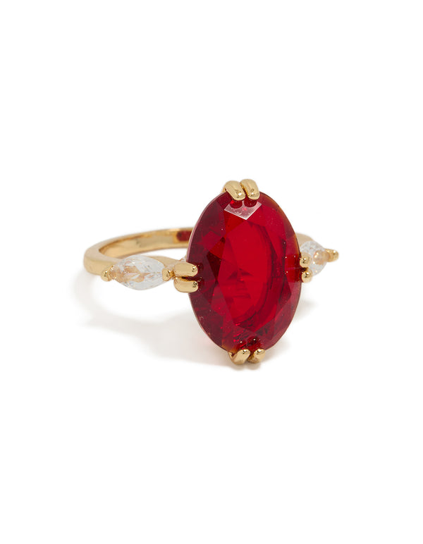 Showcasing a gold plated cubic zirconia large red oval statement ring with crystal accents front view