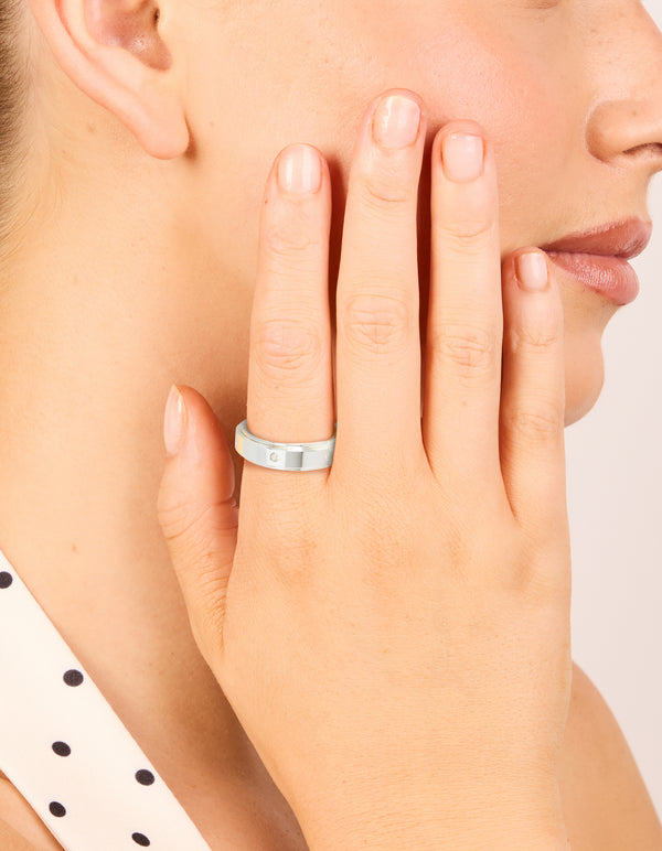 Featuring waterproof cubic zirconia stainless steel spinner ring in silver with clear accents on finger view