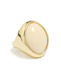 Showcasing a gold plated chunky oval cream stone ring with statement styling side detail view - link has visual effect only