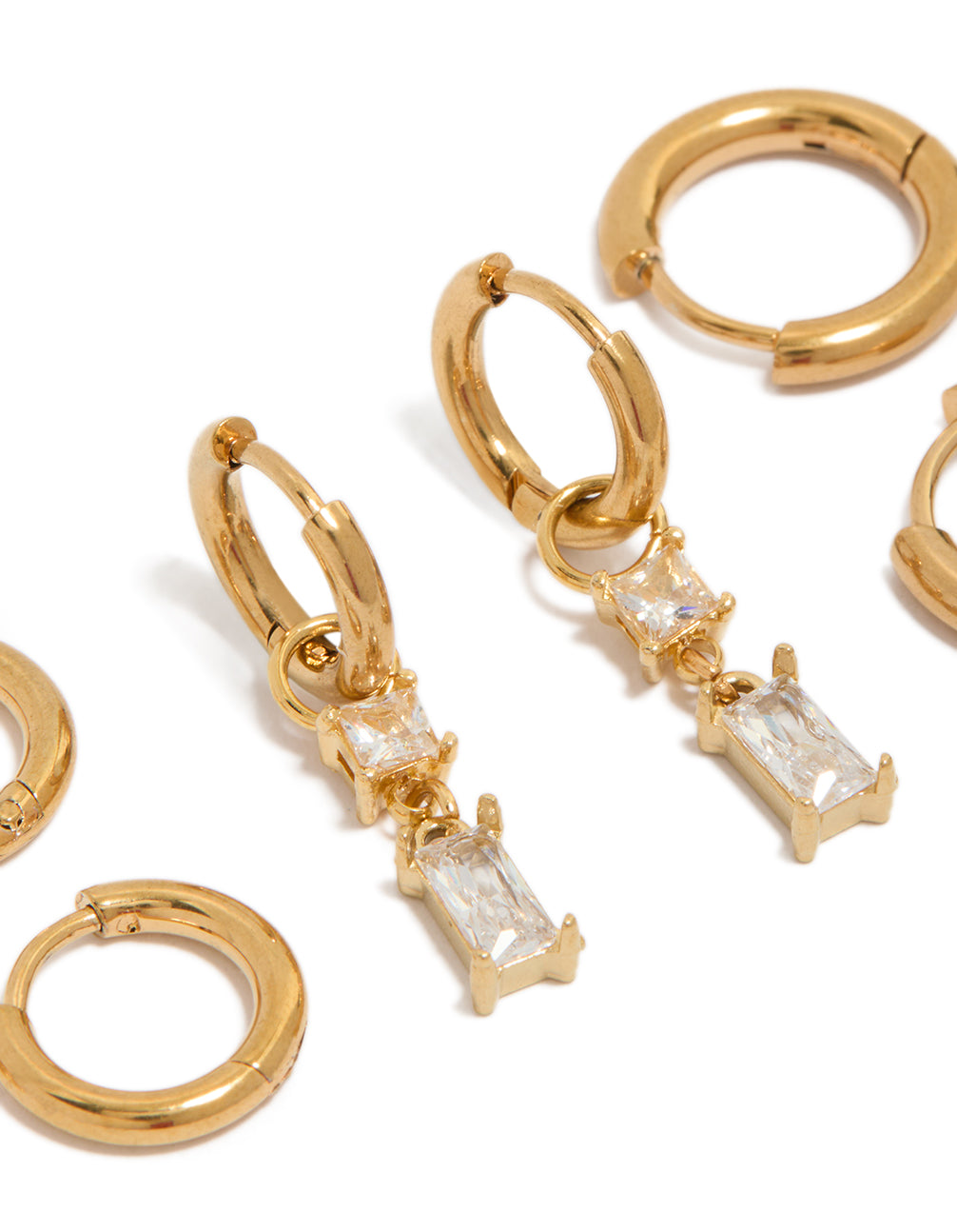 Detailed look at waterproof gold plated stainless steel huggie and stud earrings 4-pack with baguette cut cubic zirconia crystals close up view