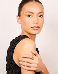 Showcasing a geometric faceted waterproof statement ring crafted from gold plated stainless steel on finger view - link has visual effect only