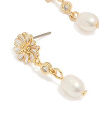 Highlighting gold plated white enamel daisy and freshwater pearl drop earrings with floral design close up view - link has visual effect only