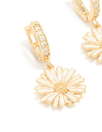 Highlighting statement floral huggie earrings crafted from gold plated materials, featuring white enamel petals and cubic zirconia details close up view - link has visual effect only