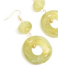 Featuring gold green acrylic circle drop earrings close up view - link has visual effect only