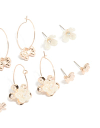 Showcasing rose gold pearlised flower and bee earrings 8-pack with bow, butterfly, heart and pearl ivory accents, stud and huggie closures on ear view - link has visual effect only