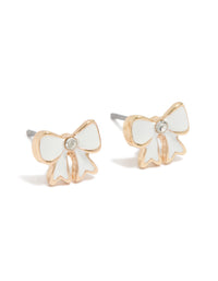 Showcasing dainty bow stud earrings with diamante centre in gold and cream enamel front view - link has visual effect only