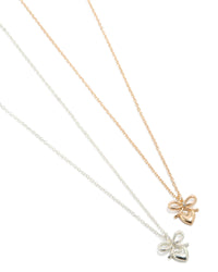 Showcasing mixed metal bow and heart pendant necklaces in gold and silver 2-pack close up view - link has visual effect only