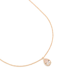Showcasing a gold cubic zirconia teardrop pendant necklace close up view - link has visual effect only